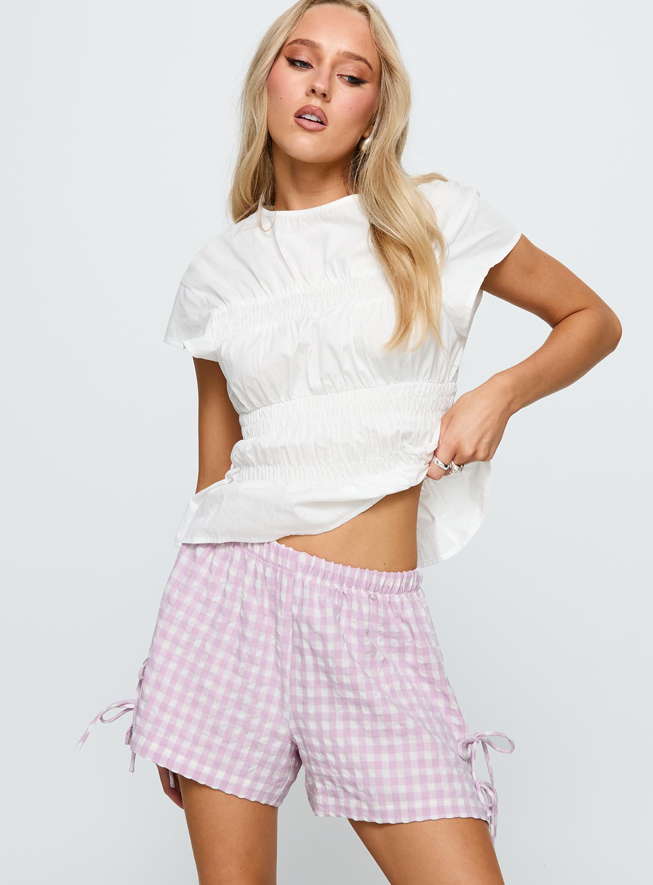 side view of model wearing Princess Polly Bubbia Tie Up Shorts Purple / White 