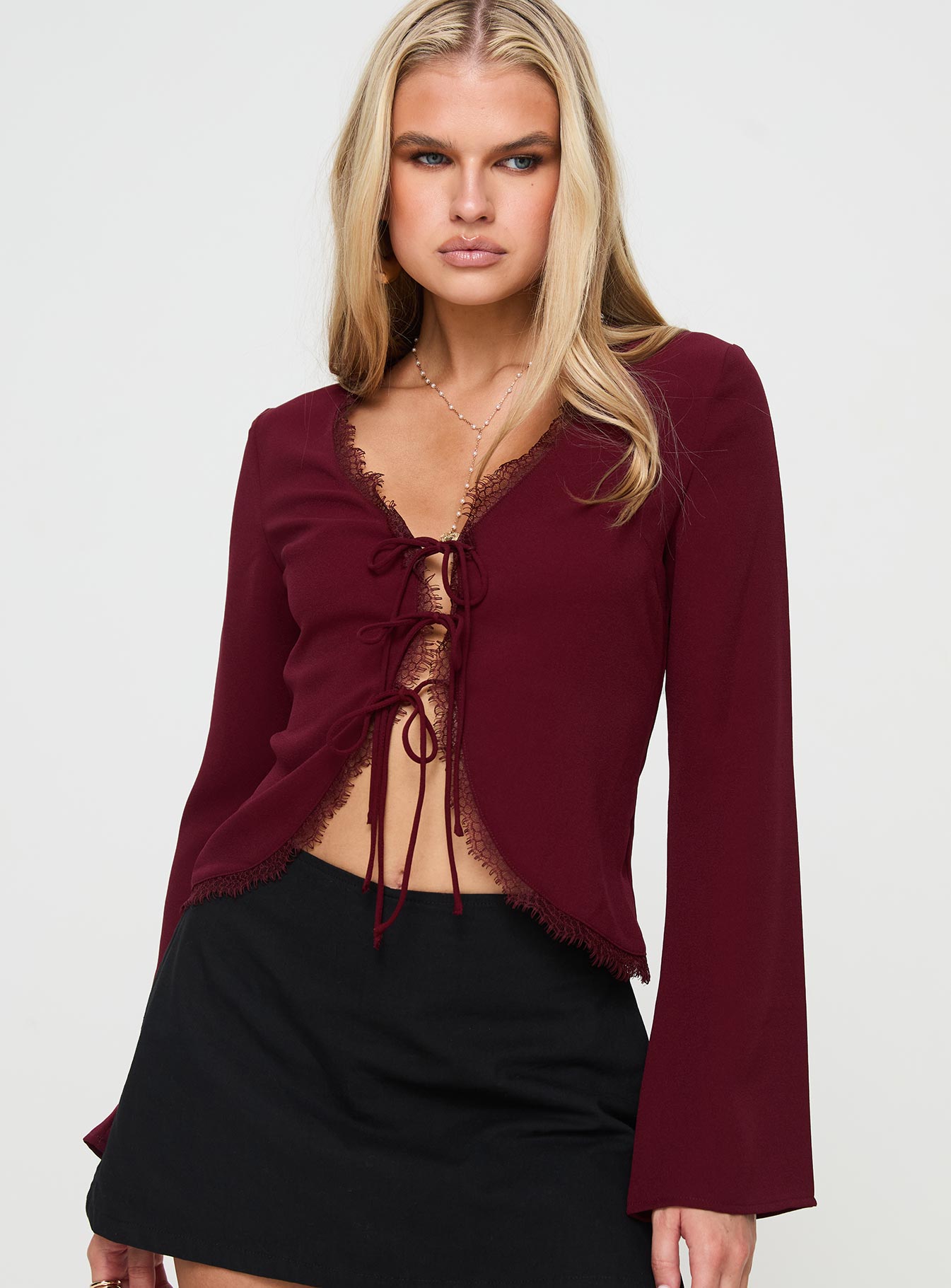 front view of model wearing Princess Polly Hagner Long Sleeve Top Burgundy Full Sleeves V-Neck 