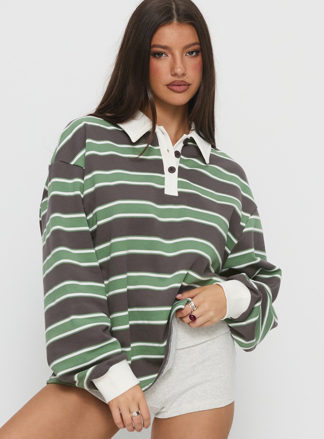 side view of model wearing Princess Polly Tycen Polo Rugby Jumper Green / Grey Stripe Long 