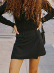 back view of model wearing Princess Polly Kinzlee Mini Skirt Black Tall Mini Skirts 