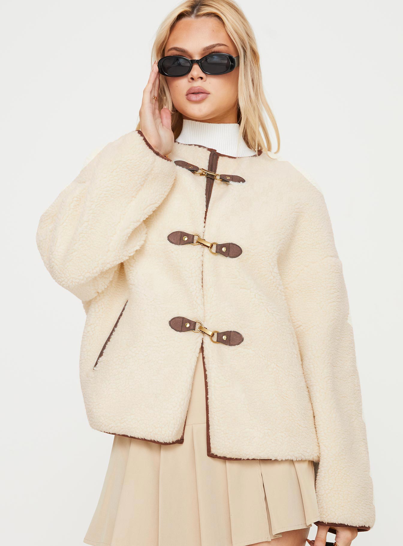 Teddy coat Relaxed fit, twin hip pockets, drop shoulder  Gold-toned clasp fastening down front 