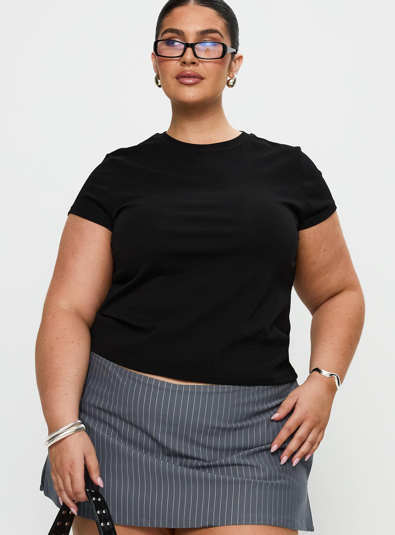 front view of model wearing Princess Polly Prestige Longline Baby Tee Black Curve Short Sleeves Crew Neck 