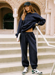 side view of model wearing Princess Polly Dream Fleece Ankle Cuff Sweatpants Navy High Waisted Pants 