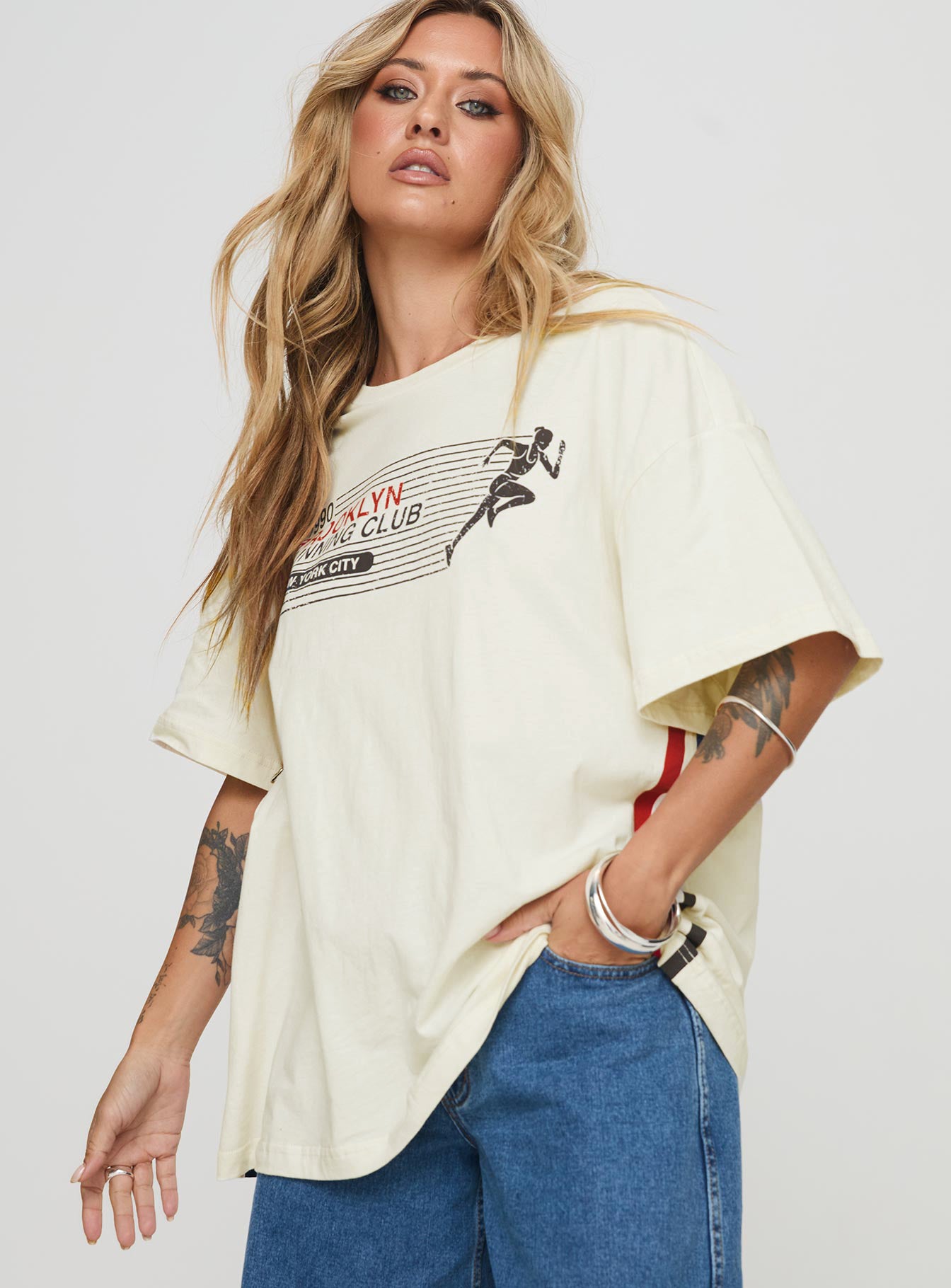 front view of model wearing Princess Polly Brklyn Running Oversized Tee White Half Sleeves Crew Neck 