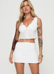 Broderie anglaise set Crop top, v-neckline, fixed shoulder straps, hook & eye fastening down front Mid rise mini skirt, invisible zip fastening down side Non-stretch material, partially lined