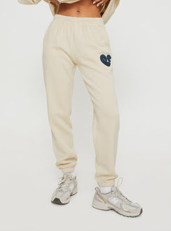 Front view of model wearing  front Princess Polly  Princess Polly Track Pants Bubble Text Stone / Slate