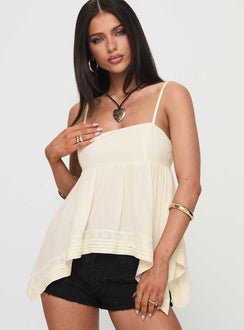 side view of model wearing Princess Polly Miku Top Cream Sleeveless Square Neck 