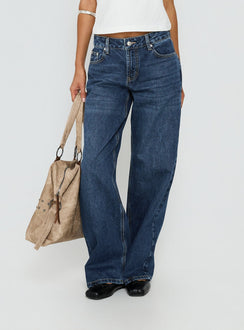 side view of model wearing Princess Polly Serenitia Mid Rise Straight Leg Relaxed Jeans Dark Blue Wash Mid Rise Jeans 