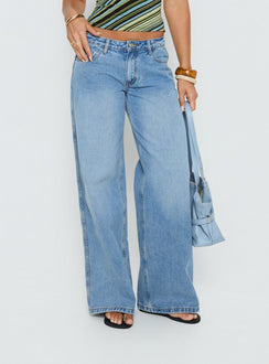 side view of model wearing Princess Polly Ramos Low Rise Denim Jeans Bright Blue Wash Mid Rise Jeans 