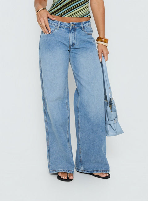 side view of model wearing Princess Polly Ramos Low Rise Denim Jeans Bright Blue Wash Mid Rise Jeans 