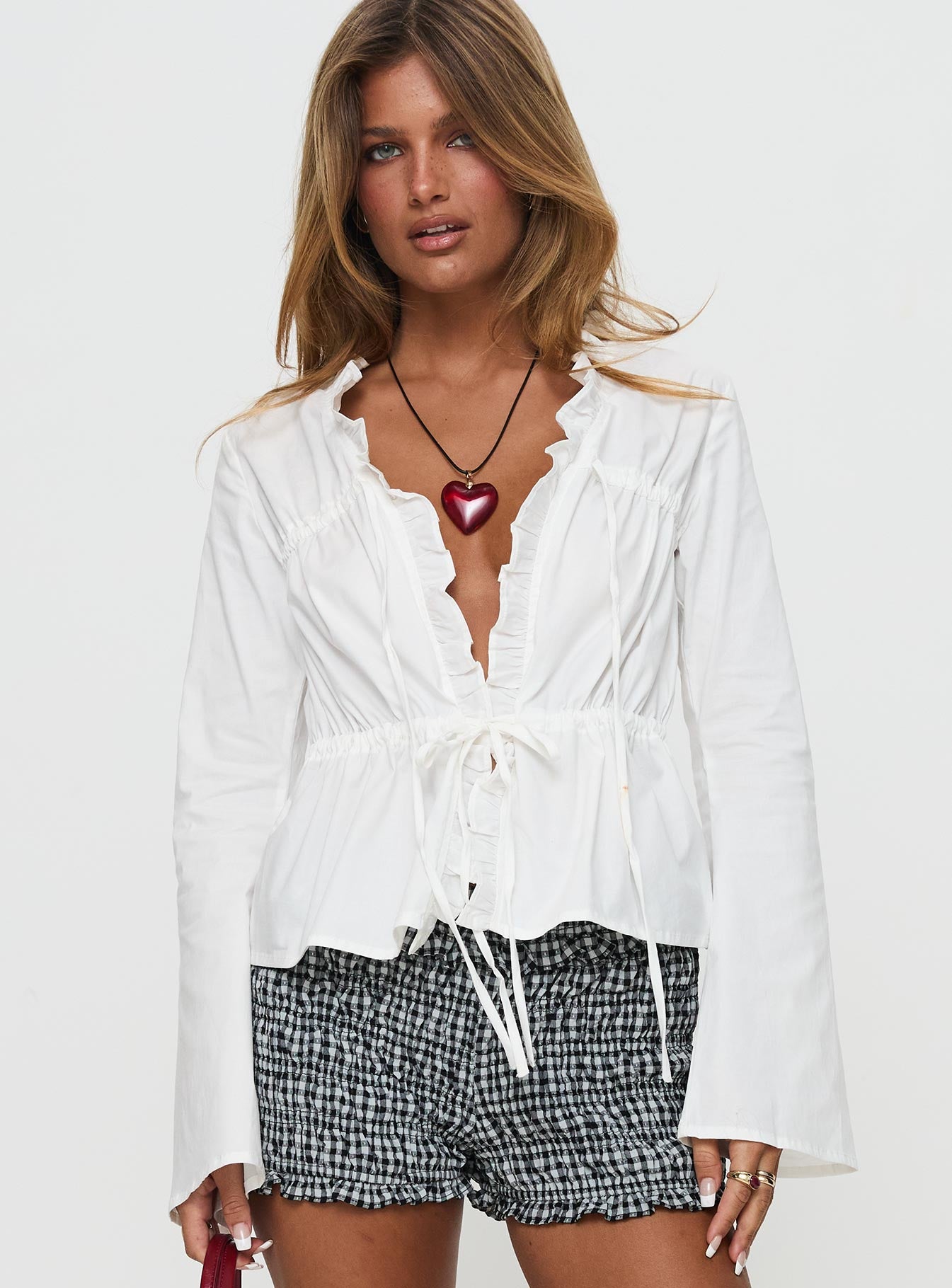 front view of model wearing Princess Polly Harloe Ruched Tie Up Long Sleeve Top White Full Sleeves V-Neck 