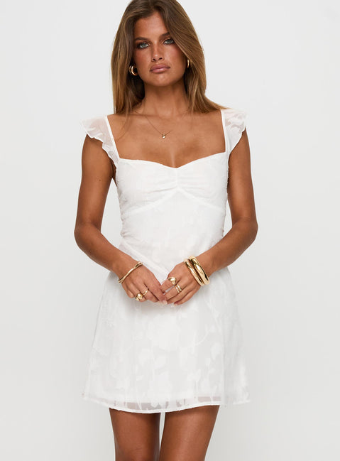 side view of model wearing Princess Polly Past And Present Burnout Tie Back Mini Dress White Sweetheart Neckline 