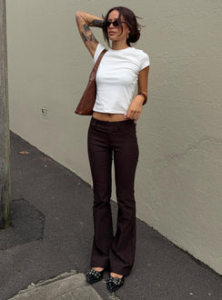 front view of model wearing Princess Polly Kinkirk Flared Pants Chocolate Petite Low Rise Pants 