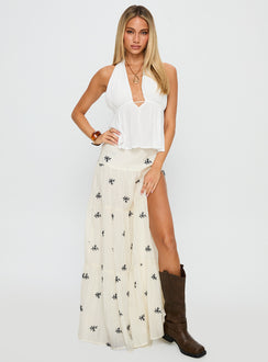   side view of model wearing Princess Polly Cinnamon Embroidered Maxi Skirt Cream / Navy Maxi 