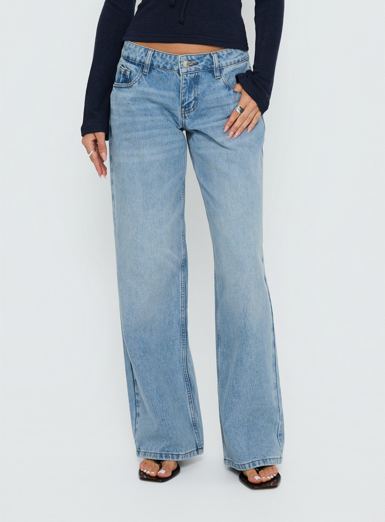 side view of model wearing Princess Polly Ellanor Low Rise Slouch Denim Jean Washed Mid Blue Wash Low Rise Jeans 