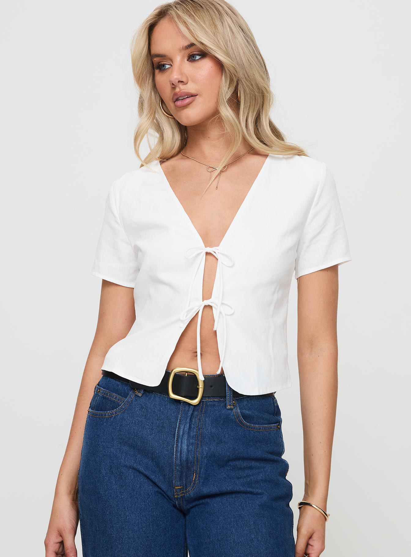 front view of model wearing Princess Polly Corriander Shirt White Short Sleeves V-Neck 