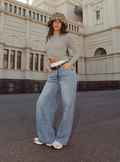 side view of model wearing Princess Polly Moonshine Wide Leg Jeans Mid Wash Mid Rise 