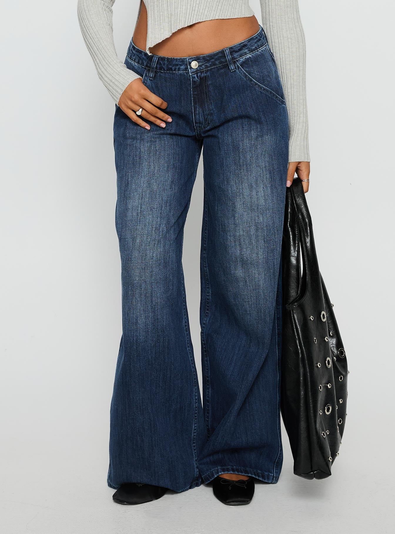 back view of model wearing Princess Polly Downtowner Low Rise Cargo Jeans Mid Blue Wash Low Rise Jeans 