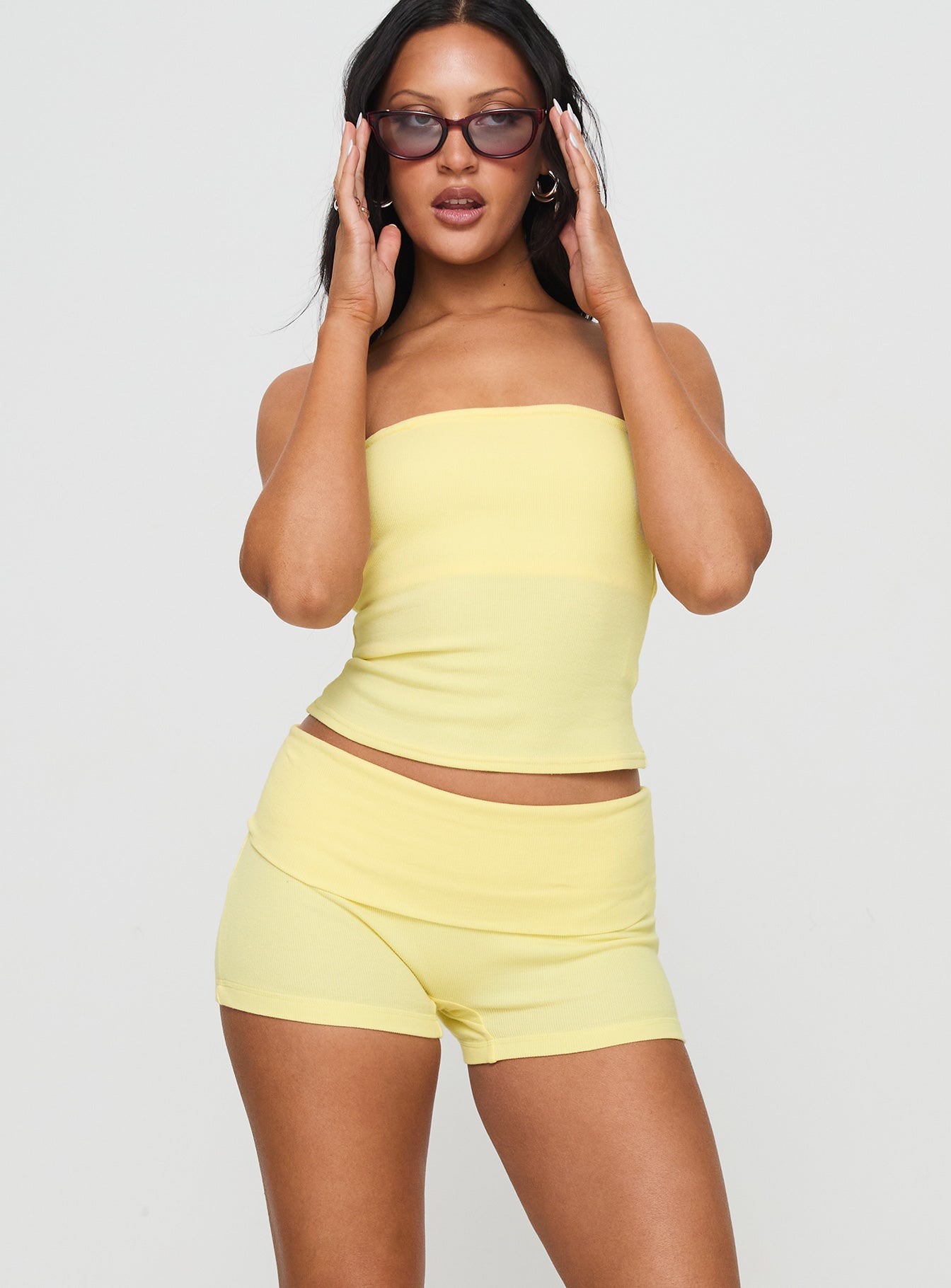 side view of model wearing Princess Polly Baseline Low Rise Rib Shorts Yellow Low Rise Shorts 