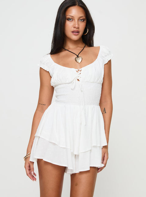 White Romper Cap sleeves, cross over tie fastening at bust, elasticated waist, layered hem