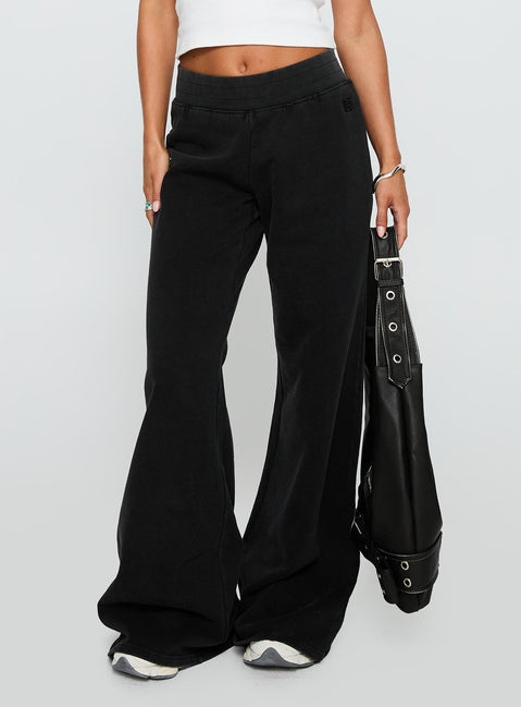 side view of model wearing Princess Polly Summits Flared Track Pants Washed Black High Waisted Pants 