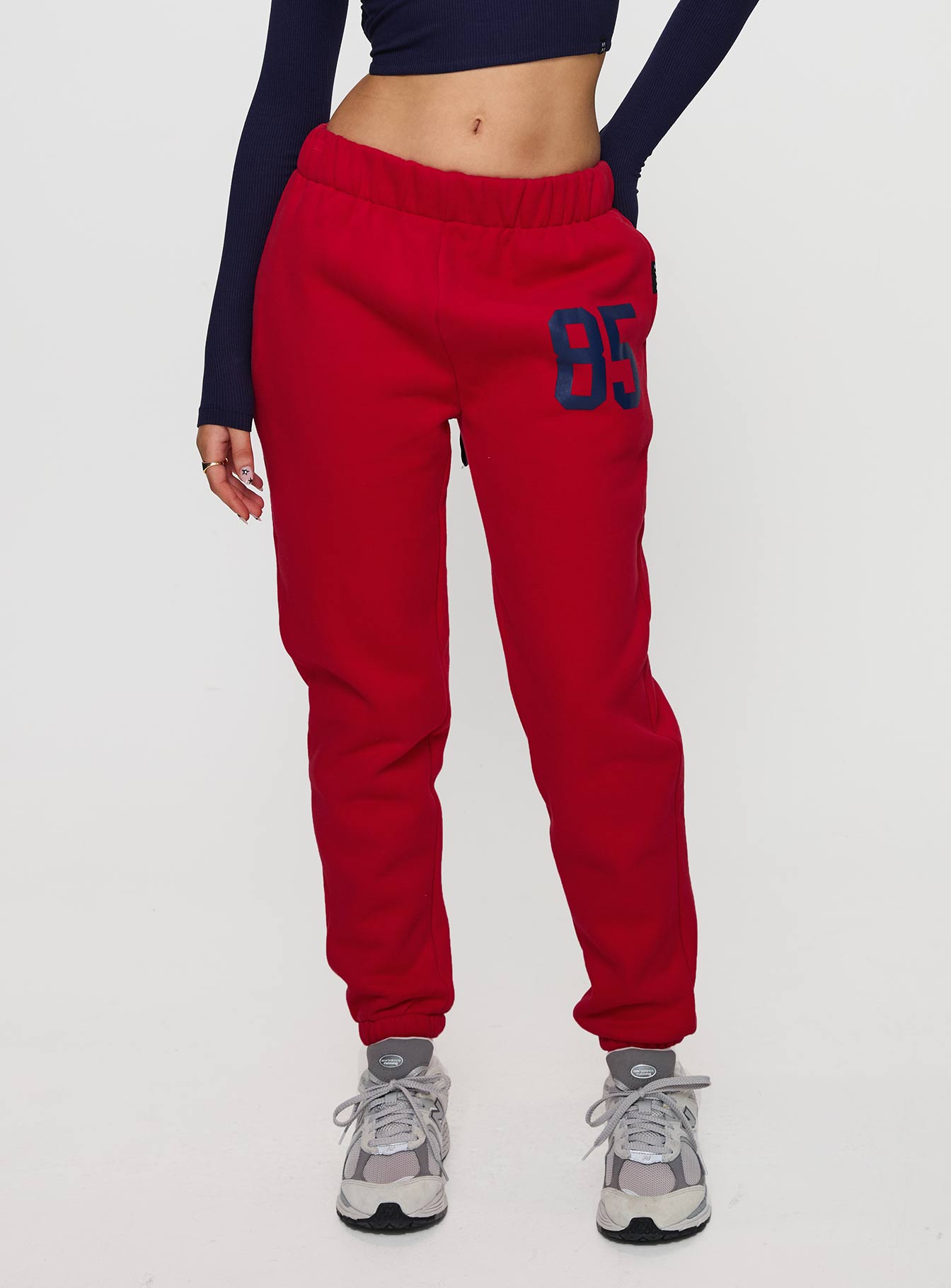 front view of model wearing Princess Polly U of A Sweatpants Red Low Rise Pants 