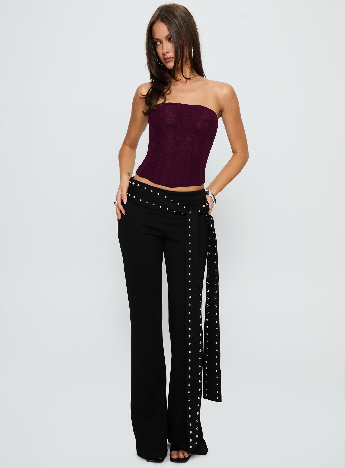 front view of model wearing Princess Polly Nikolia Studded Wrap Belt Pants Black Mid Rise Pants 