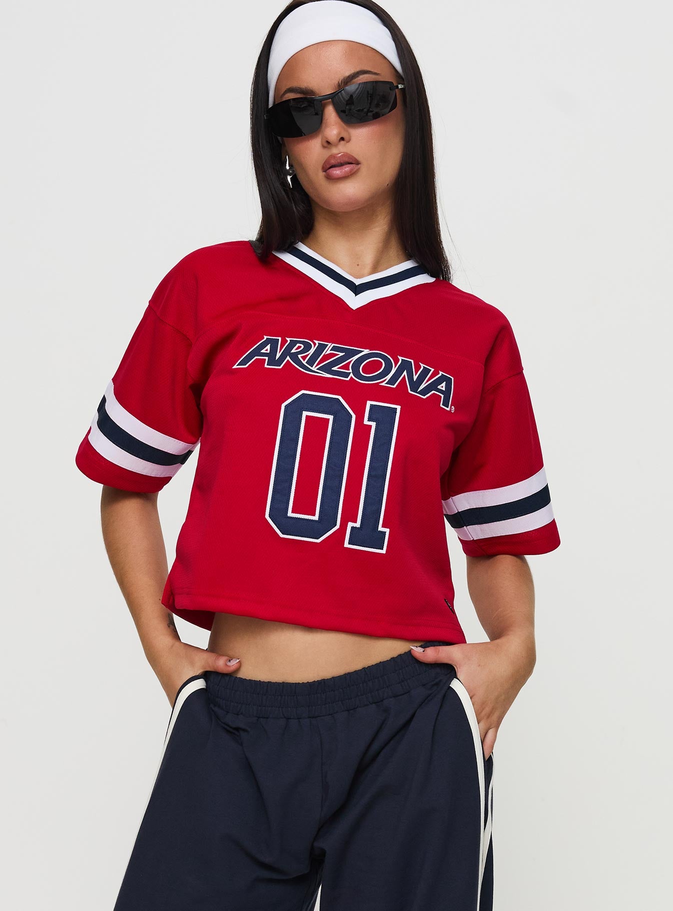 front view of model wearing Princess Polly U of A Football Jersey Red Half Sleeves V-Neck 