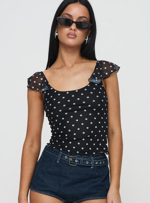 front view of model wearing Princess Polly Beckinsale Polka Top Black Short Sleeves Scoop Neck 