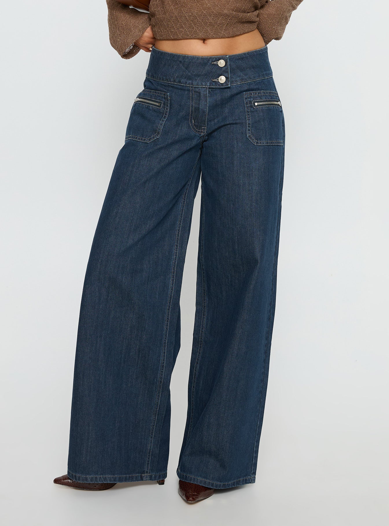 side view of model wearing Princess Polly Unwritten Mid Rise Wide Leg Jeans Dark Blue Wash Mid Rise Jeans 