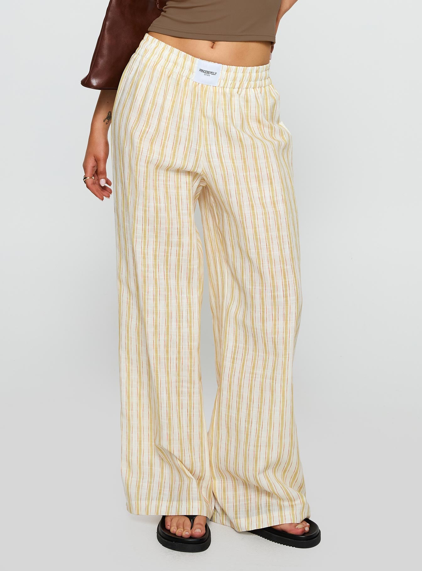 side view of model wearing Princess Polly Beach House Pants Yellow Stripe High Waisted Pants 