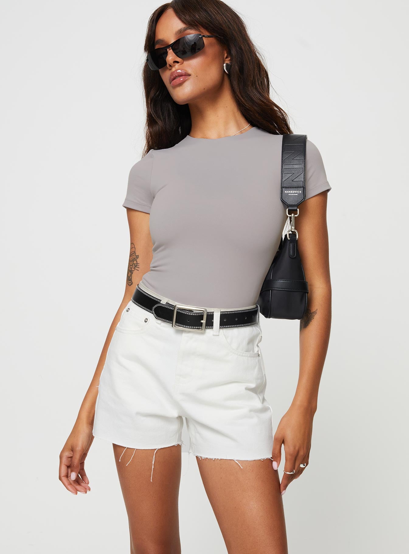 front view of model wearing Princess Polly Jannika Shorts White Denim High Waisted Shorts 