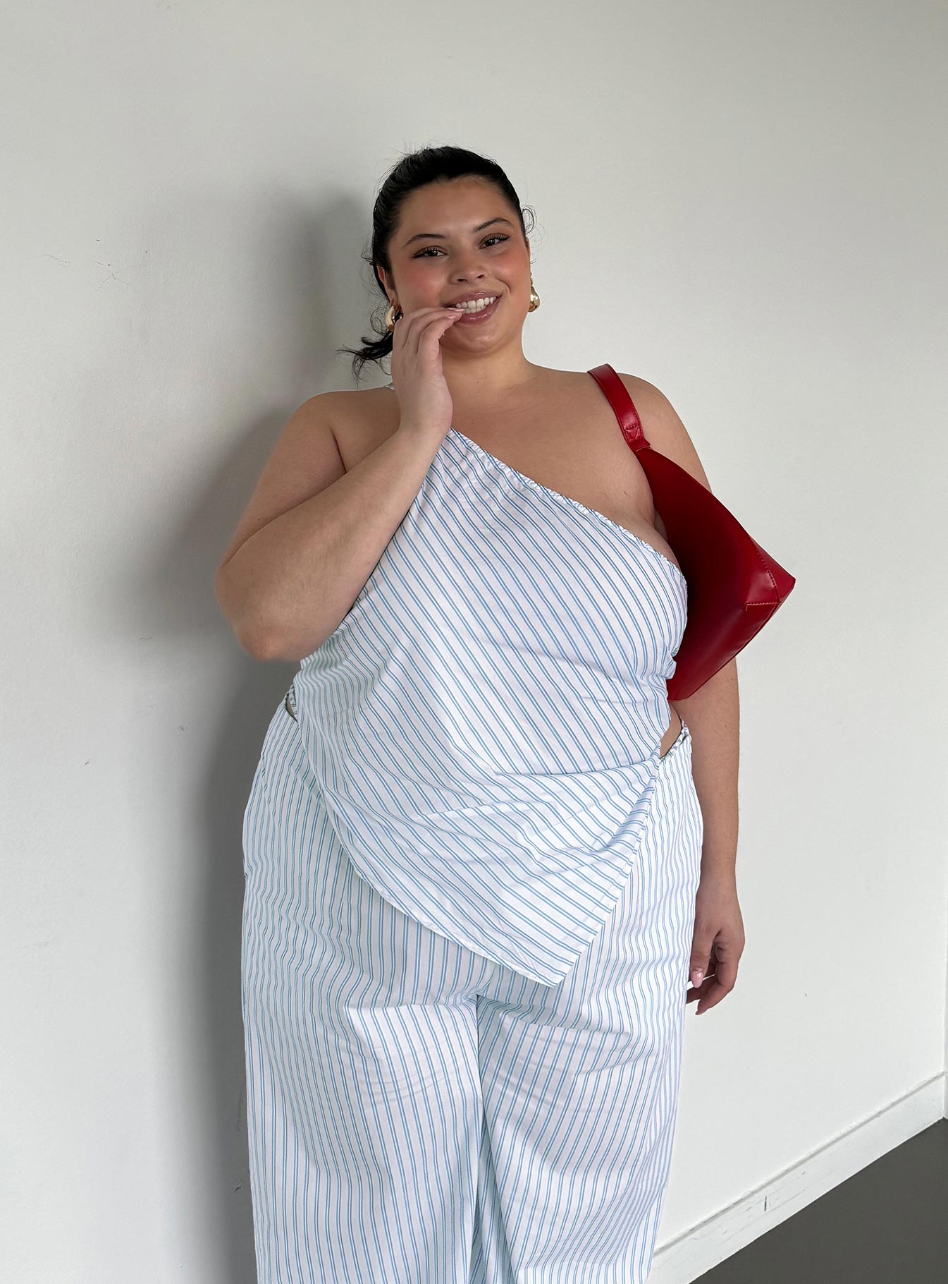 side view of model wearing Princess Polly Collied Asymmetric Top Blue / White Stripe Curve Sleeveless Asymmetric Neckline 