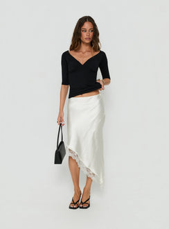 Featuring the Koletta Asymmetrical Lace Trim Satin Midi Skirt in Ivory with fitted silhouette front view of model wearing Princess Polly
