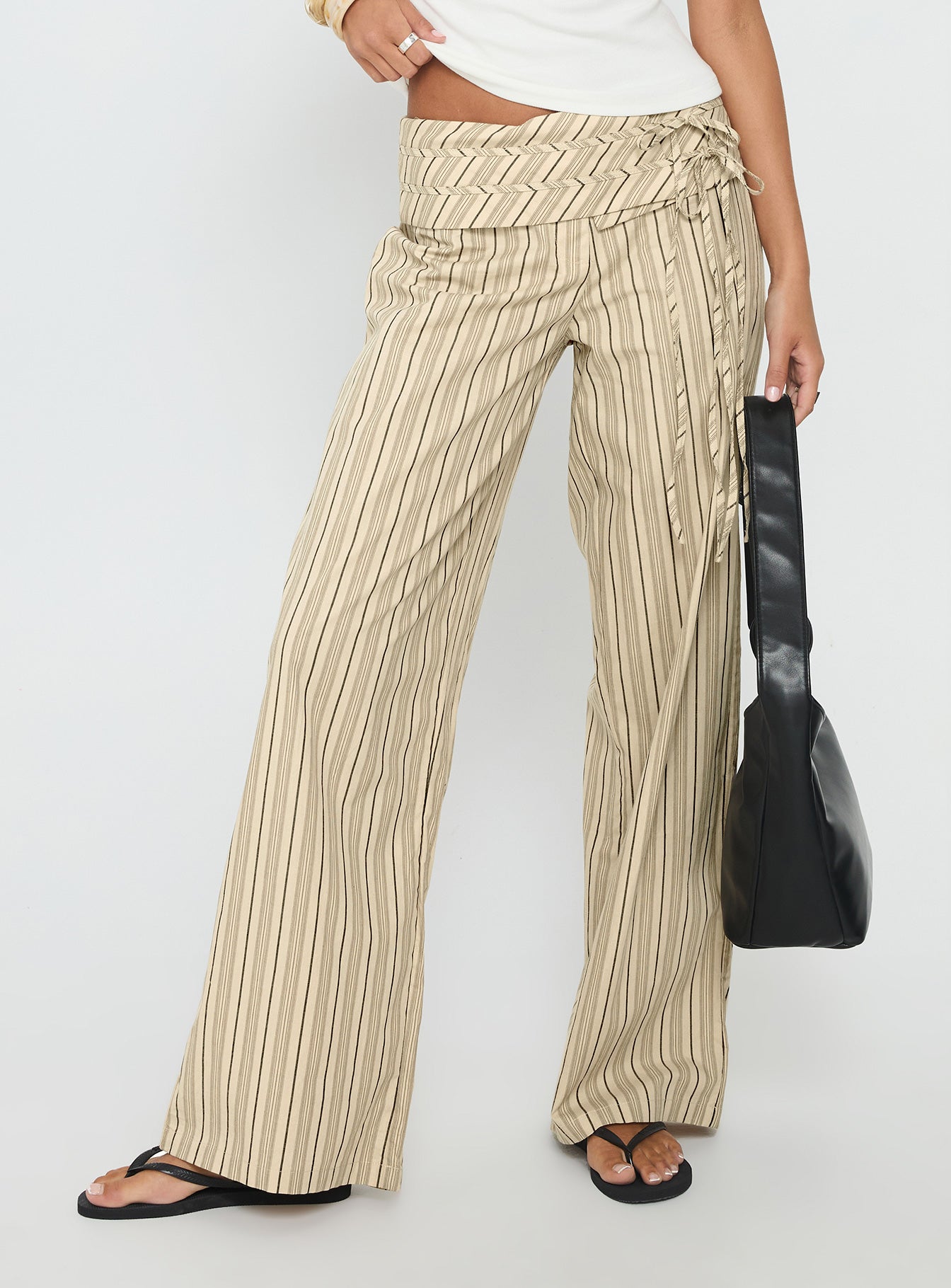 side view of model wearing Princess Polly Seneca Wrap Pant Beige Stripe Mid Rise Pants 