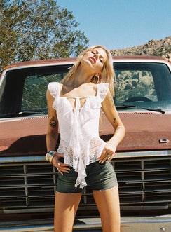 side view of model wearing Princess Polly Martinne Low Rise Shorts Antique Wash High Waisted Shorts 