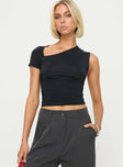 side view of model wearing Princess Polly Stela Top Black Sleeveless Asymmetric Neckline 