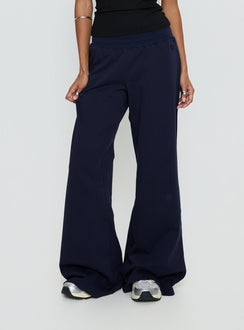 back view of model wearing Princess Polly Summits Flared Track Pants Navy Mid Rise Pants 