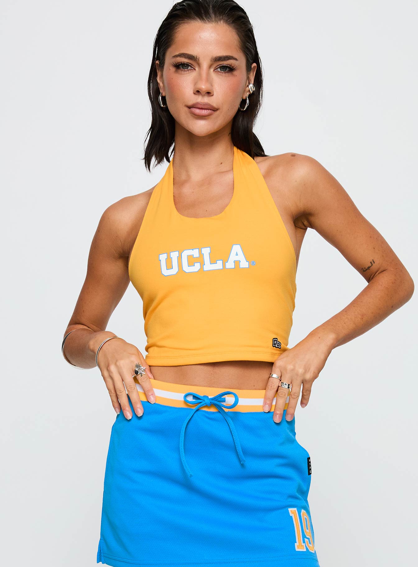 front view of model wearing Princess Polly UCLA Tailgate Halter Top Gold Sleeveless Scoop Neck 