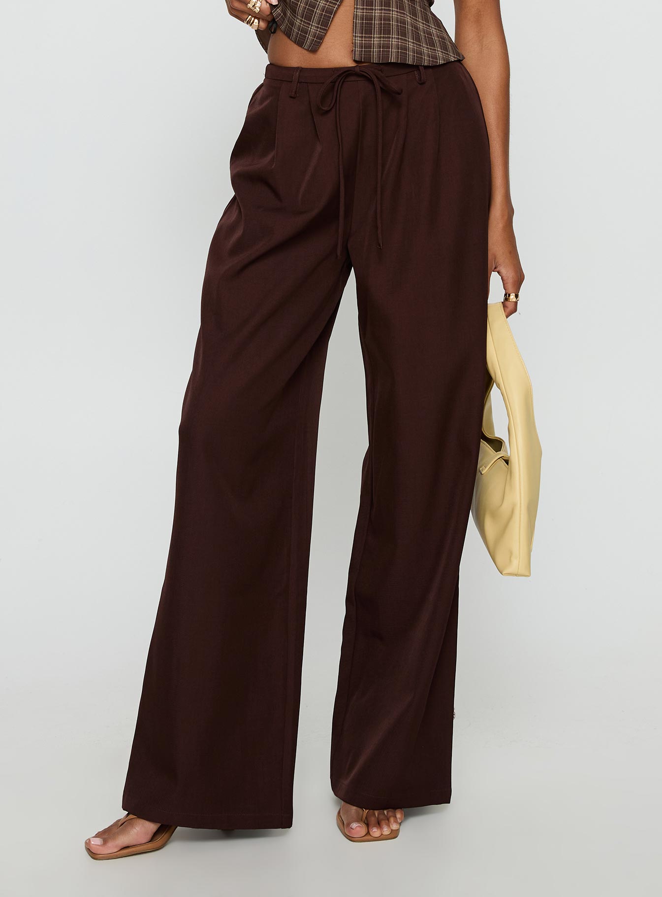 back view of model wearing Princess Polly Idolised Pleated Tie Waist Pant Chocolate Brown Mid Rise Pants 