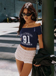 side view of model wearing Princess Polly Serendipia Off The Shoulder Graphic Top Navy Short Sleeves straight 