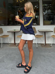 side view of model wearing Princess Polly Gigi Skort White Lower Impact High Waisted Shorts 