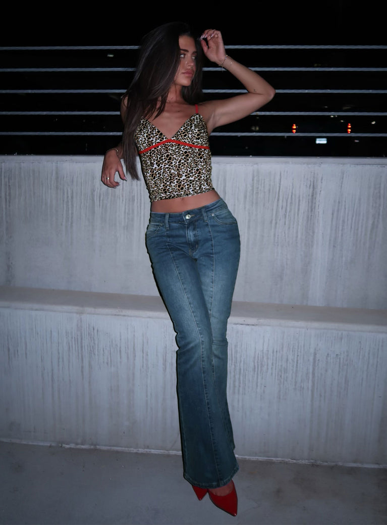 side view of model wearing Princess Polly Iker Flared Jeans Mid Wash Mid Rise 