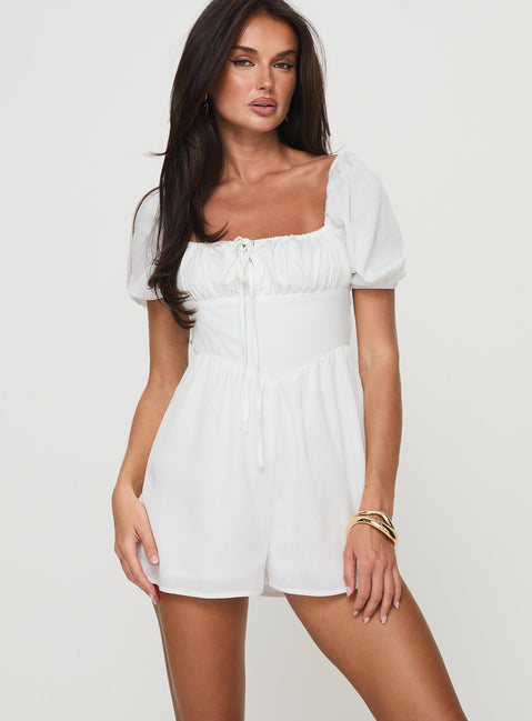 Romper Puff sleeve, square neckline, adjustable ruching at bust with tie fastening, invisible zip fastening down back Non-stretch material, partially lined Princess Polly Lower Impact