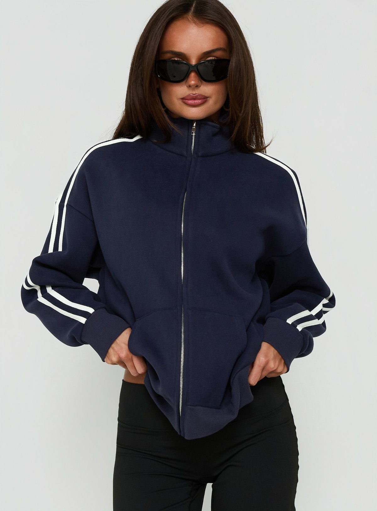 Crafted from fleece, the Keeran Funnel Neck Jumper Navy / White in womens category with short length side view of model wearing Princess Polly