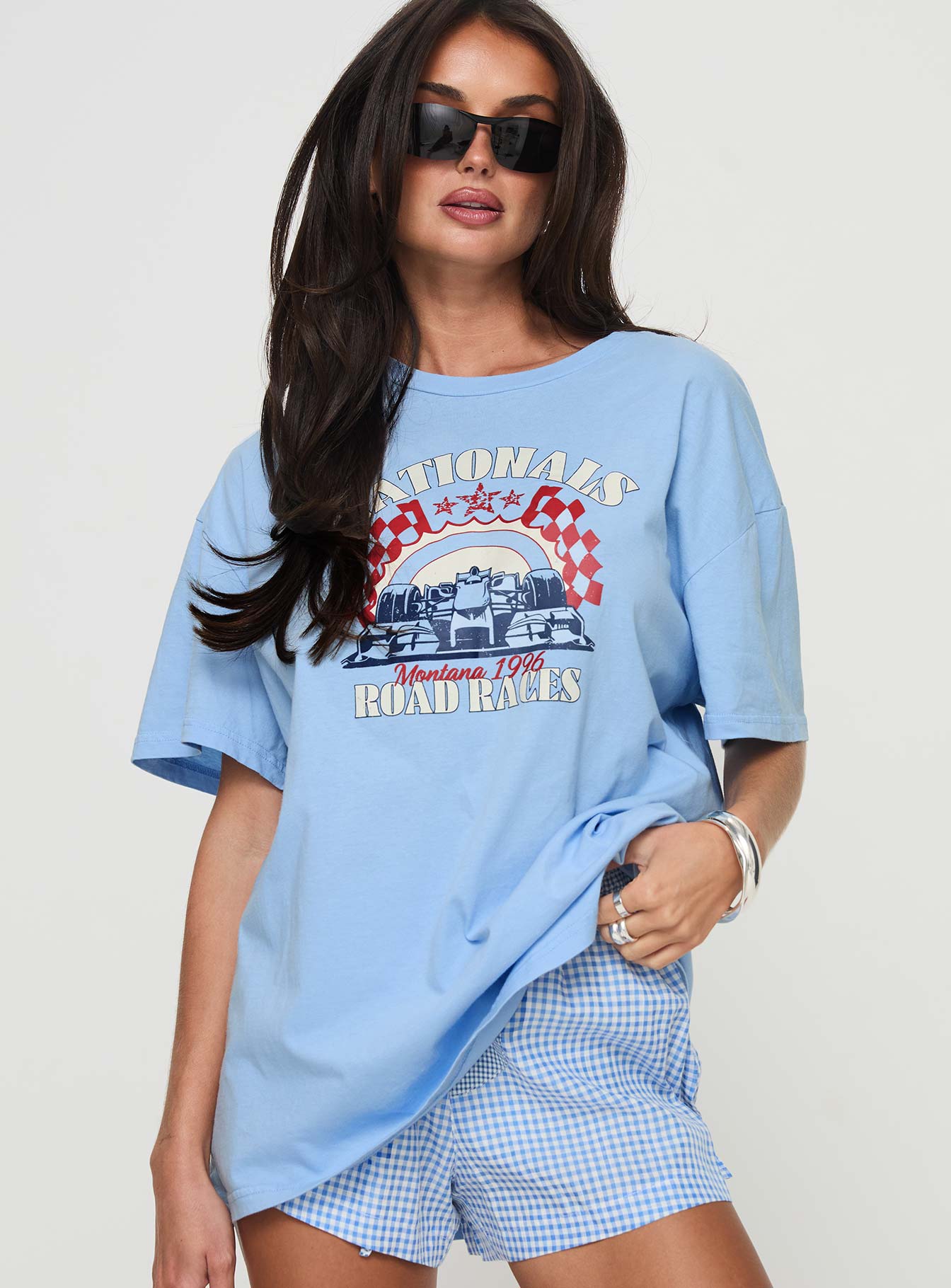 back view of model wearing Princess Polly Races 1996 Oversized Tee Blue Half Sleeves Crew Neck 
