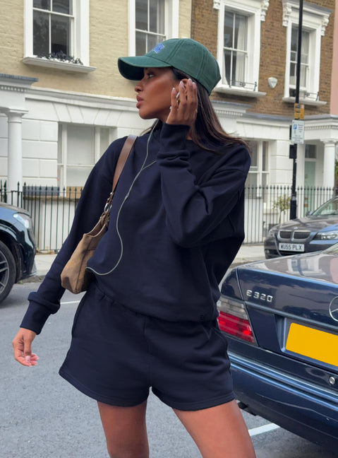 front view of model wearing Princess Polly All Day Shorts Navy High Waisted Shorts 