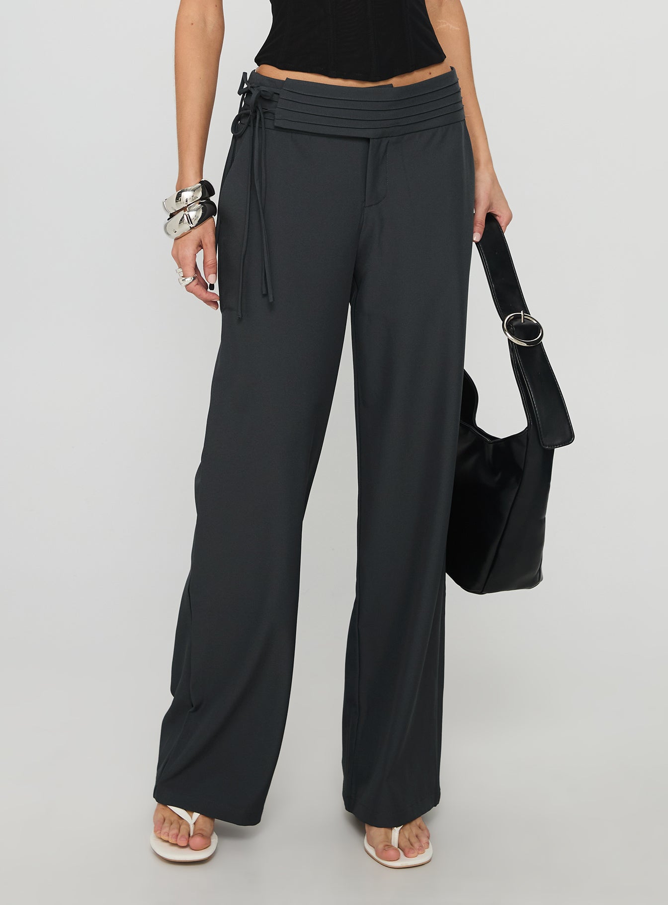 back view of model wearing Princess Polly Good Riddance Pleat Tie Slouch Pants Charcoal Low Rise Pants 