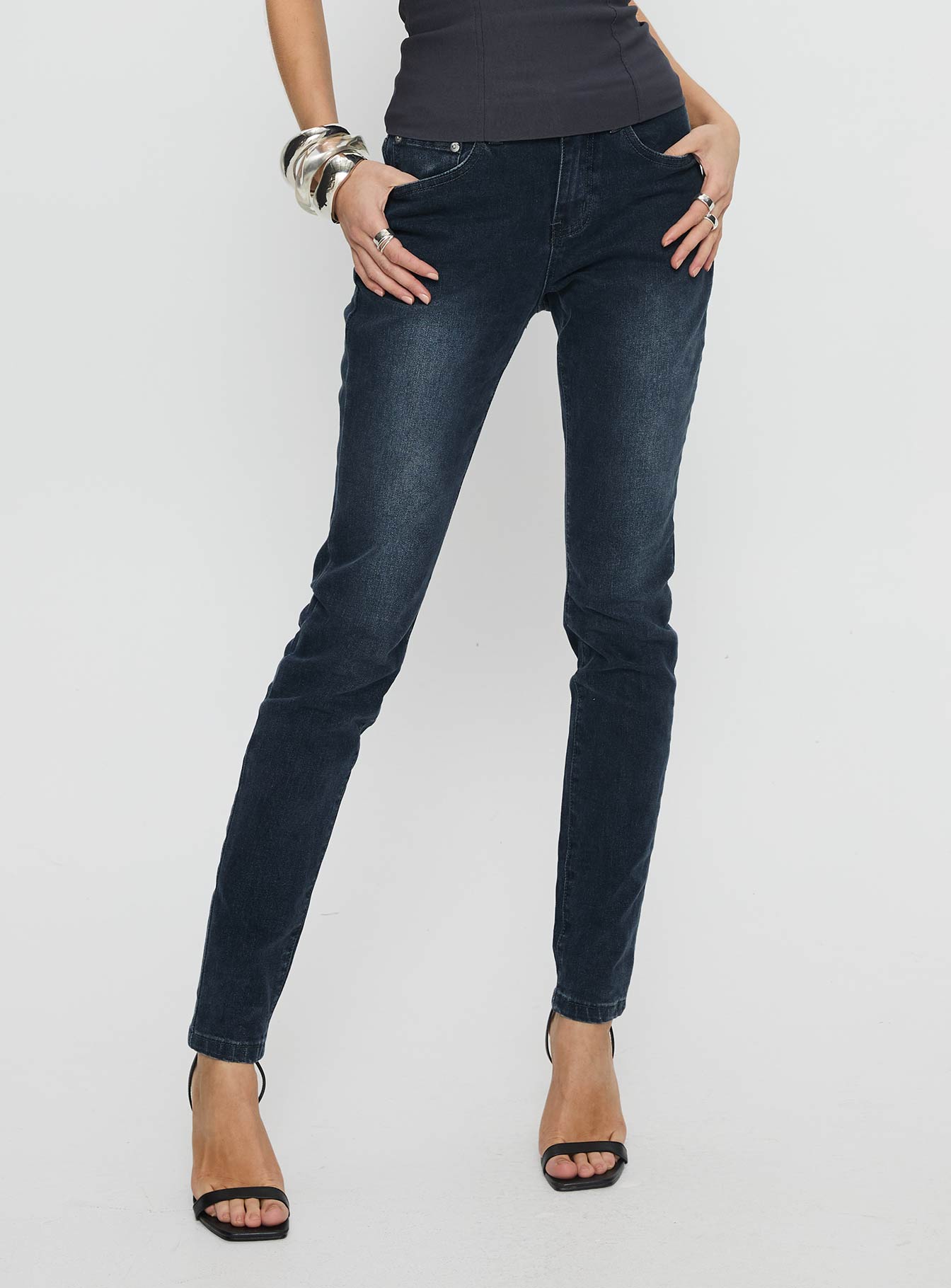 front view of model wearing Princess Polly Illyssa Mid Rise Skinny Jeans Washed Charcoal Mid Rise Jeans 