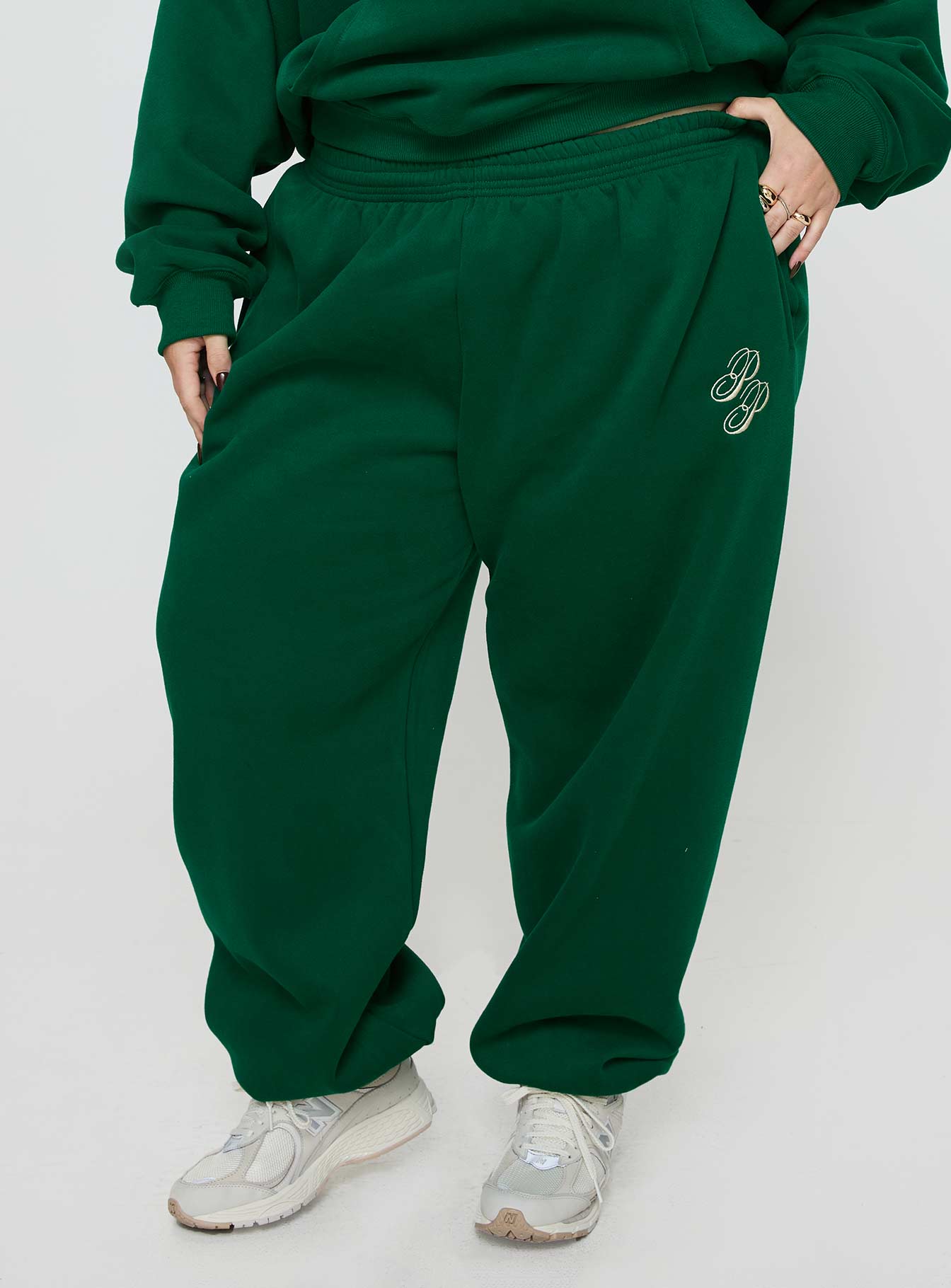 front view of model wearing Princess Polly Princess Polly Track Pants Script Green / Ivory Curve High Waisted Pants 